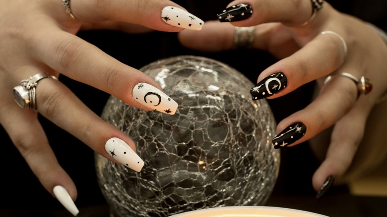 woman with black and white star nails