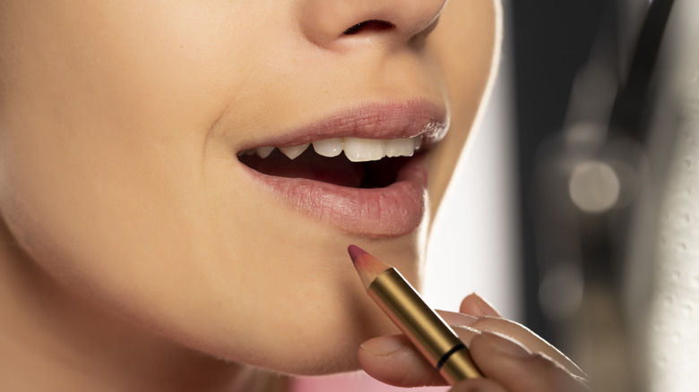 woman applying lip liner