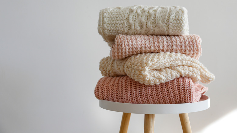 knitwear folded on chair