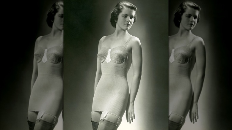 A black and white photo of a woman wearing modest lingerie