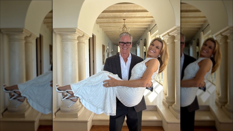 John Donaldson holds Vanna White who wears a halter-neck white wedding dress
