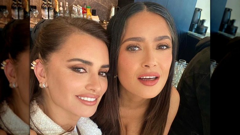 Salma Hayek showing off her grays while posing with Penelope Cruz