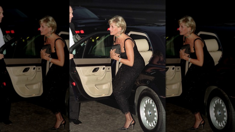 Princess Diana exiting a car with a black clutch held against her chest