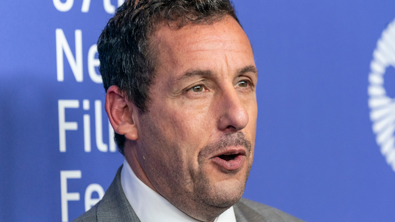 Adam Sandler walking a red carpet