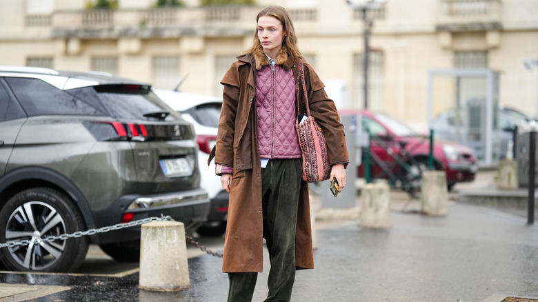 trench coat jeans and tan loafers