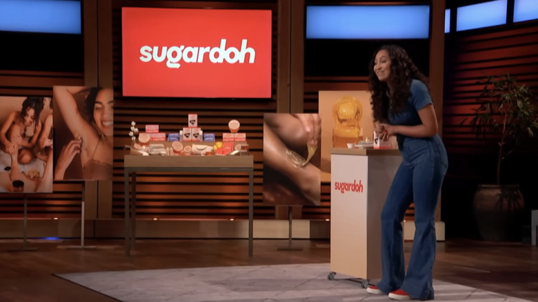 Sugardoh founder Aliyah Marandiz standing by her display on Shark Tank.