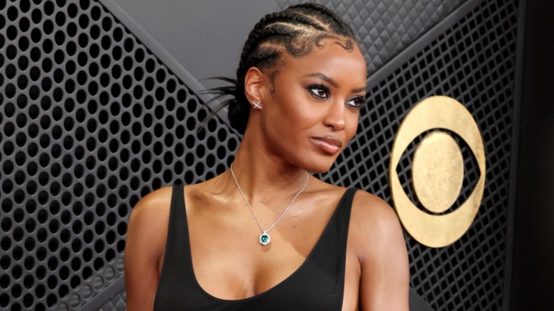 Close-up image of Ciara Miller posing on the Grammys red carpet.