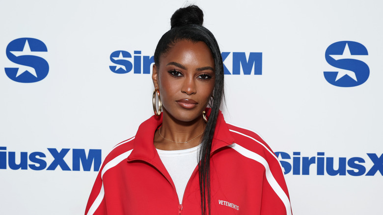 Ciara Miller posing at a SiriusXM event.