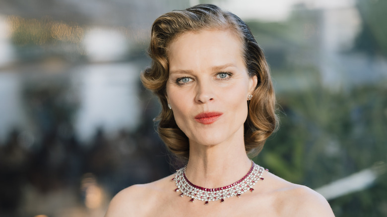 Eva Herzigová with coiffed hair wearing a ruby and diamond statement necklace attending 2026 Cannes Film Festival.