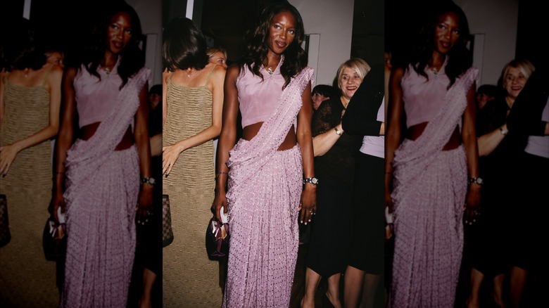 Naomi Campbell wearing a light-purple draped dress.