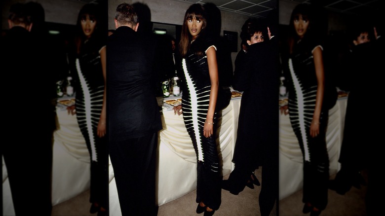 Naomi Campbell wearing a black-and-white illusion maxi dress at an event.
