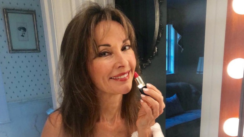 Susan Lucci applying red lipstick