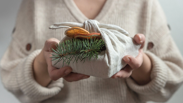 Woman holding cloth-wrapped gift