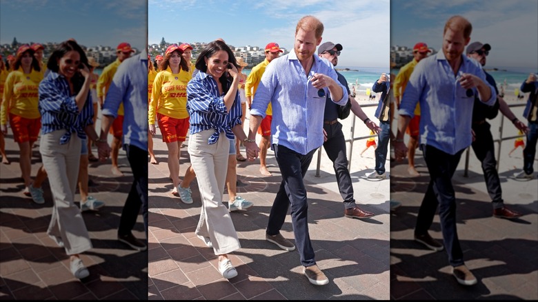 Prince Harry and Meghan Markle walking together while holding hands.