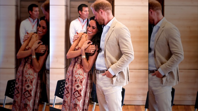 Prince Harry gives Meghan Markle an affectionate forehead kiss in Colombia