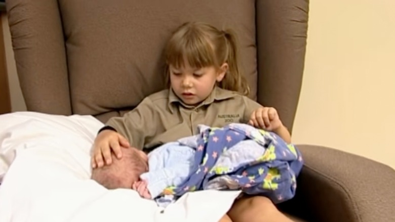 Bindi Irwin holds baby brother in her lap