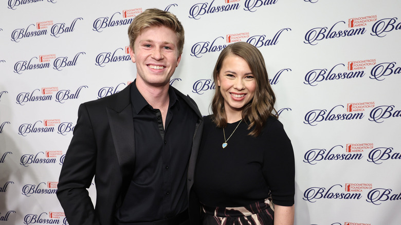 Robert Irwin and Bindi Irwin smile together in matching black