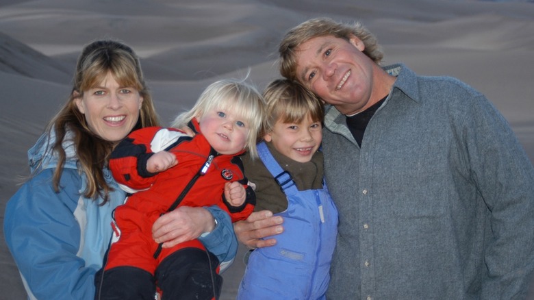 Terri Irwin, Robert Irwin, Bindi Irwin, and the late Steve Irwin smile for a photo
