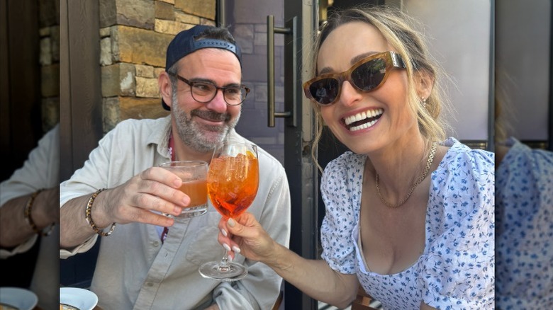 Shane Farley and Giada De Laurentiis toast each other in Colorado
