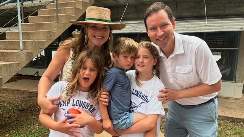 Jenna Bush Hager posing with her kids Poppy, Hal, and Mila and her husband Henry outside.