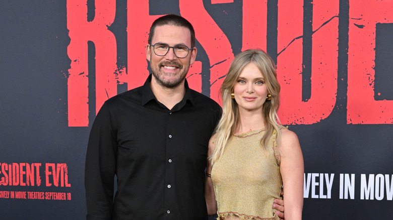 Zach Cregger and Sara Paxton smile together on the red carpet