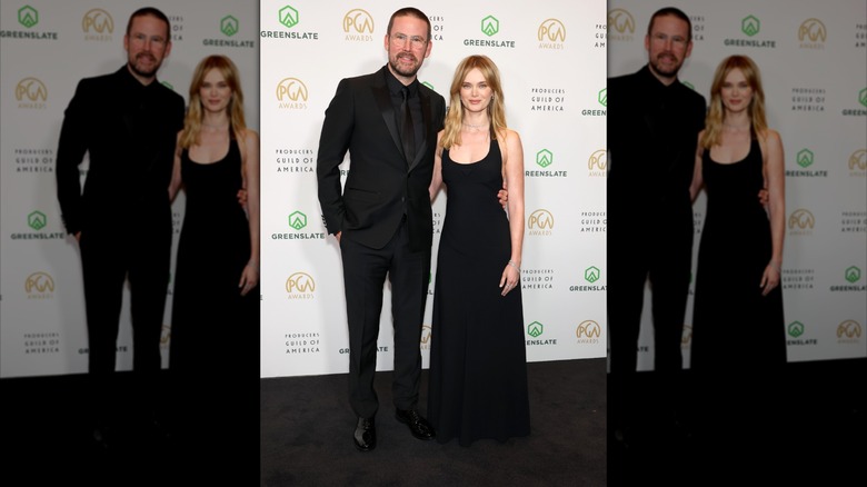 Zach Cregger and Sara Paxton smile together in all black attires