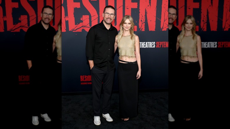 Zach Cregger and Sara Paxton hug on the red carpet