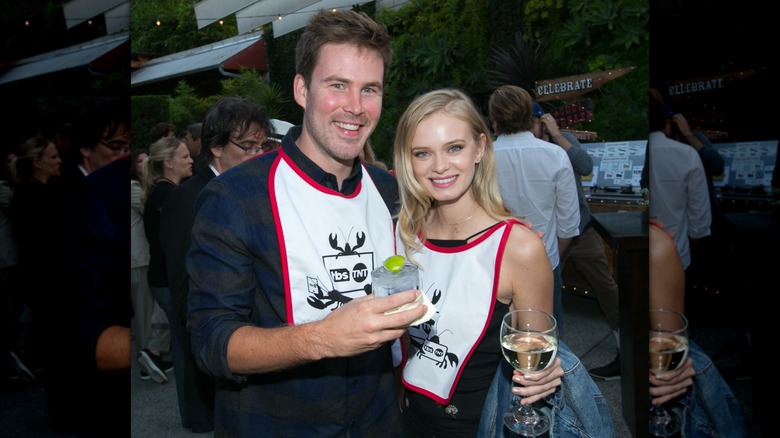 Zach Cregger and Sara Paxton smiling together and holding drinks