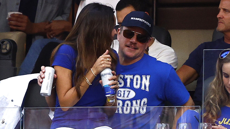 Luciana Barroso sits on Matt Damon's lap during the 2022 Super Bowl