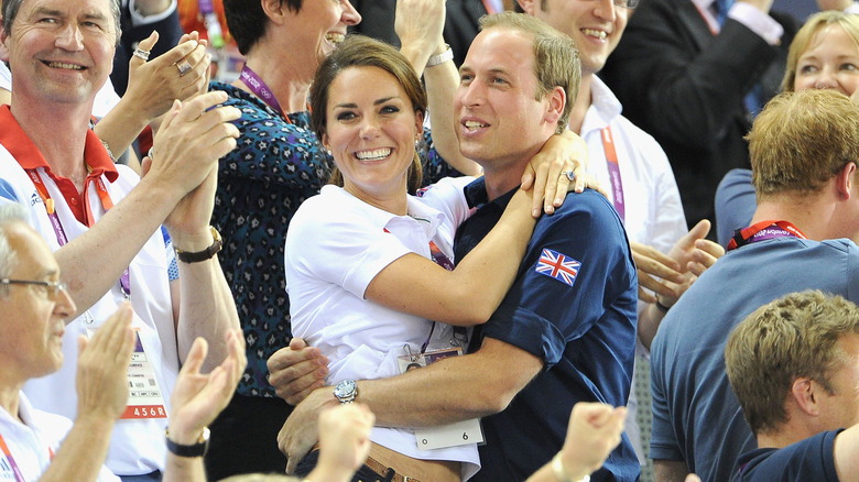 Prince William and Kate Middleton hug each other and cheer on team Britain at the 2012 Olympics