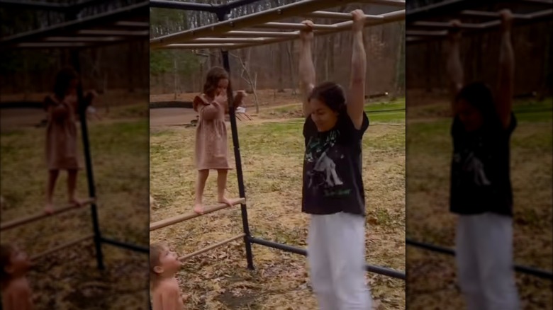 Shawn Johnson hangs on monkey bars