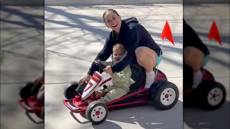Shawn Johnson rides on a motorized car with her son Barrett
