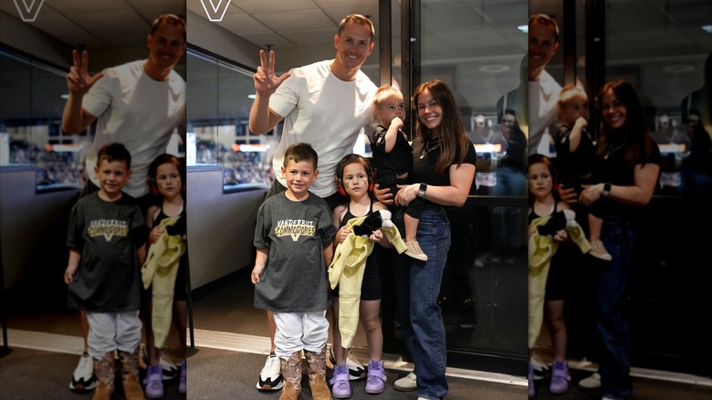 Shawn Johnson, Andrew East, and their three kids pose for a photo