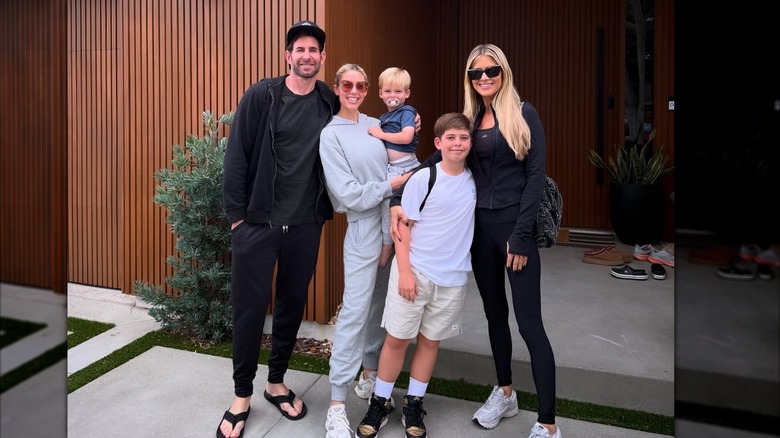 Tarek El Moussa, Heather Rae El Moussa, Tristan, Brayden, and Christina Haack smile together wearing casual clothes.