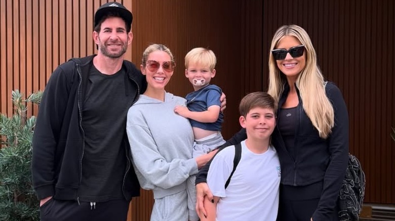Tarek El Moussa, Heather Rae El Moussa, Tristan, Brayden, and Christina Haack smile together wearing casual clothes.
