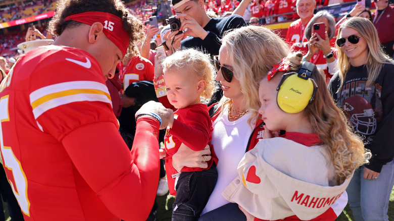 Patrick and Brittany Mahomes with two of their children after a Chiefs win