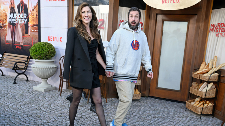 Jackie Sandler and Adam Sandler hold hands