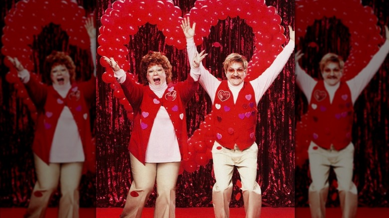 Melissa McCarthy and Ben Falcone wearing red sweaters