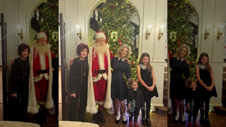 Kelly Osbourne posing with Santa, her son Sidney and Sharon Osbourne