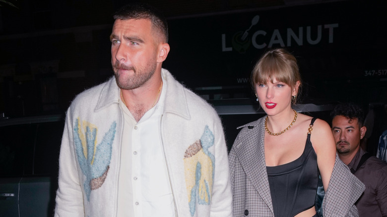 Travis Kelce and Taylor Swift are pictured walking hand-in-hand during a New York City outing.
