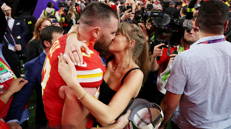 Taylor Swift and Travis Kelce embrace on the field after the Kansas City Chiefs' won Super Bowl LVIII.