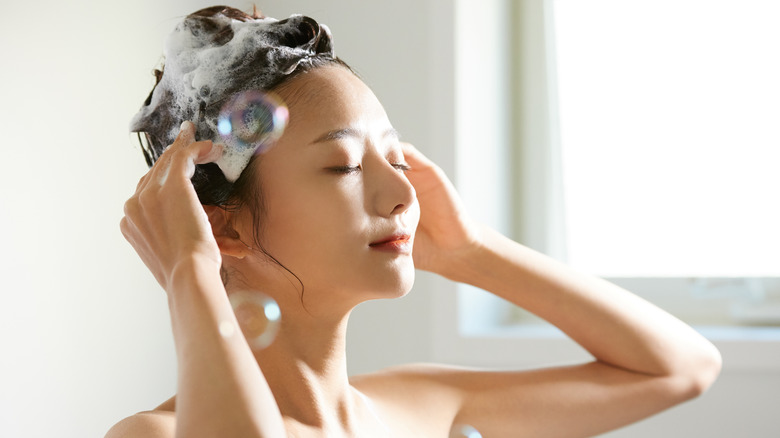 Girl shampooing her hair