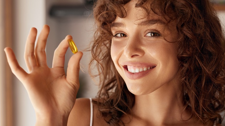 woman holding a pill