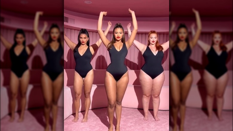 Three models in black swimsuits