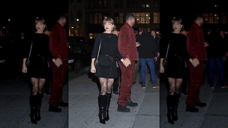 Taylor Swift wears a black top and skirt with floral tights while out with Travis Kelce