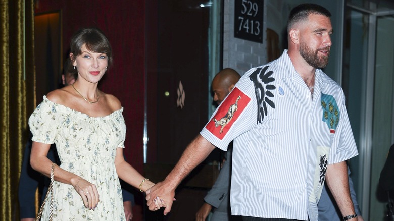 Taylor Swift and Travis Kelce holding hands during a 2025 outing in NYC.