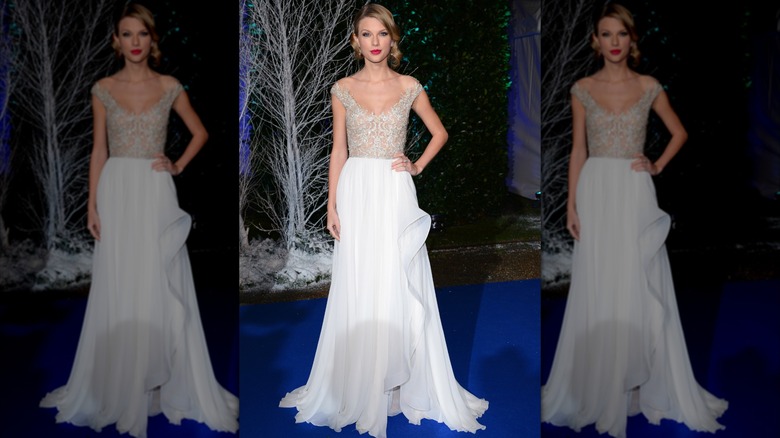 Taylor Swift poses with a hand on her hip at the 2013 Winter Whites Gala