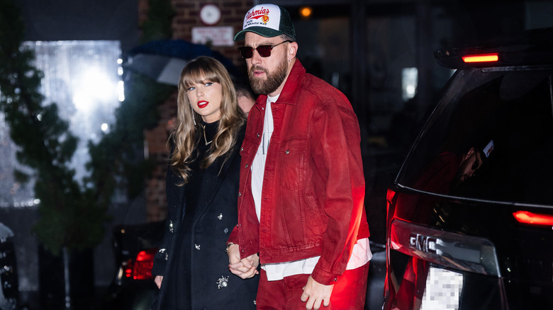 Taylor Swift and Travis Kelce holding hands while walking in Meatpacking District