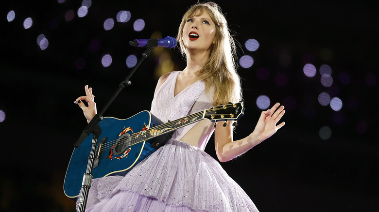Taylor Swift performing in purple