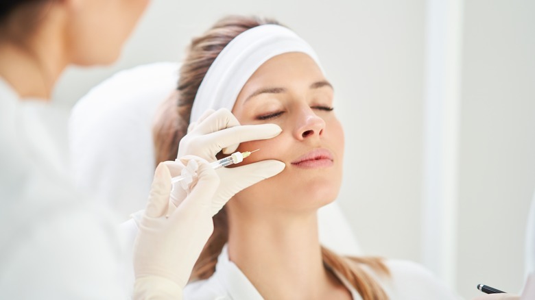 relaxed woman getting filler injection